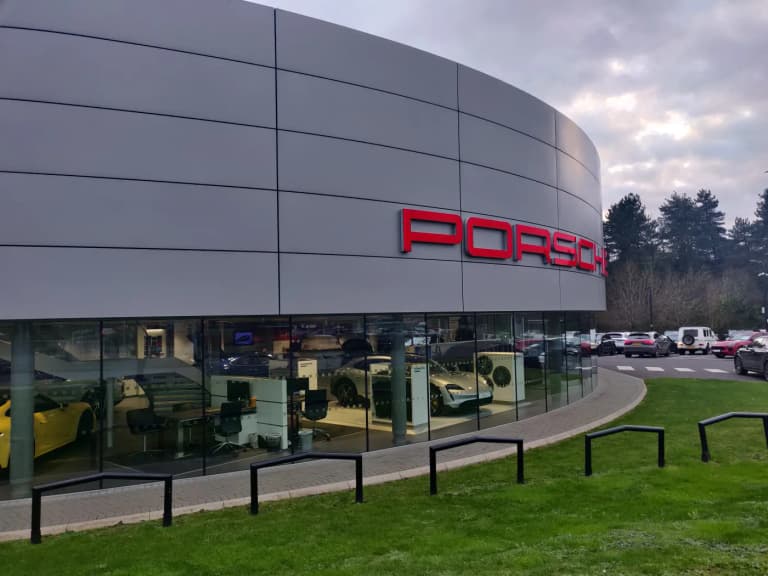 Porsche Center showroom exterior with cars on display