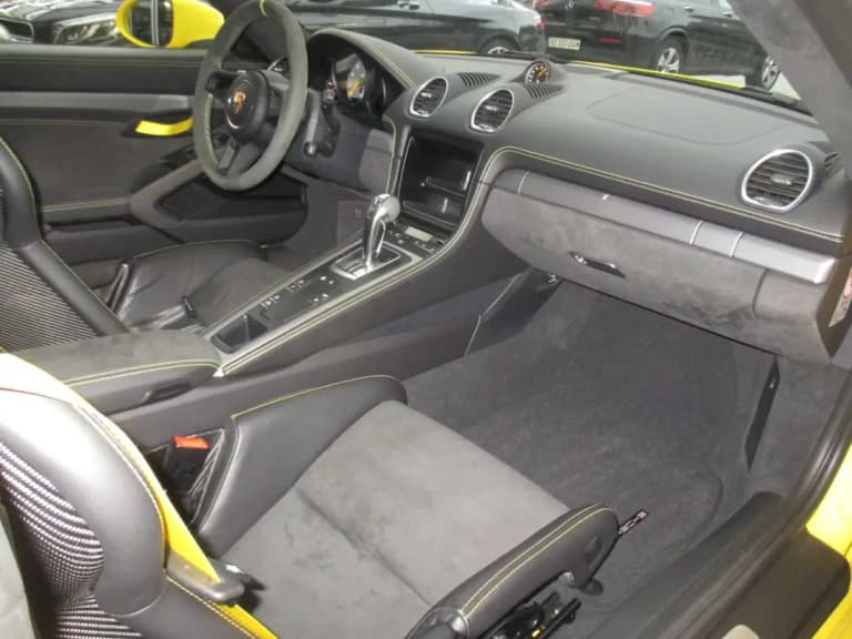 Porsche 718 GT4 interior with Alcantara wheel, sport seats, and contrast stitching