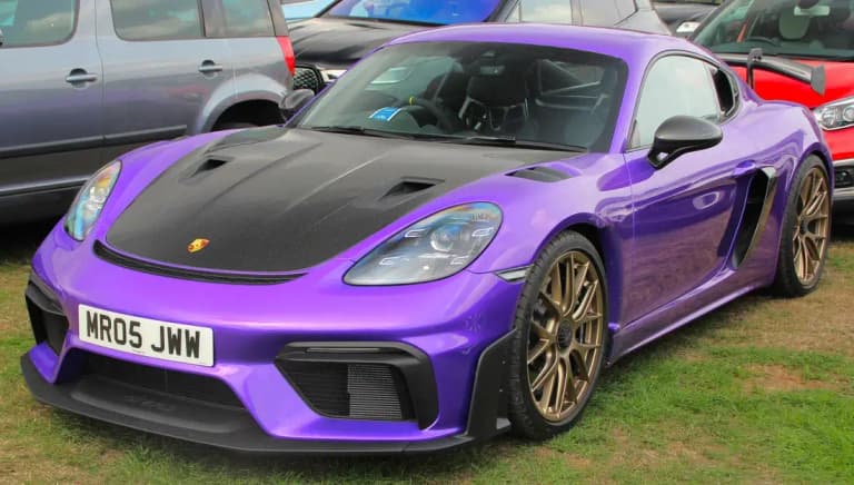Purple Porsche 718 Cayman GT4 RS with carbon hood and bronze wheels