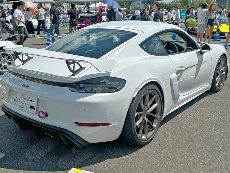 White Porsche 718 Cayman GT4 RS rear showing swan-neck rear wing