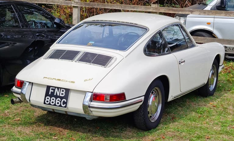 Rear of a white 1965 Porsche 911, one of the first-year cars.