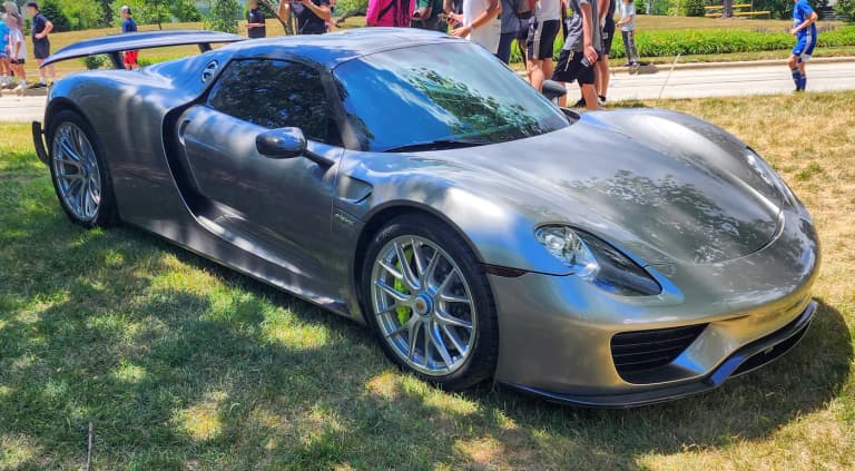 Dark gray Porsche 918 Spyder front three-quarter view at an outdoor car show