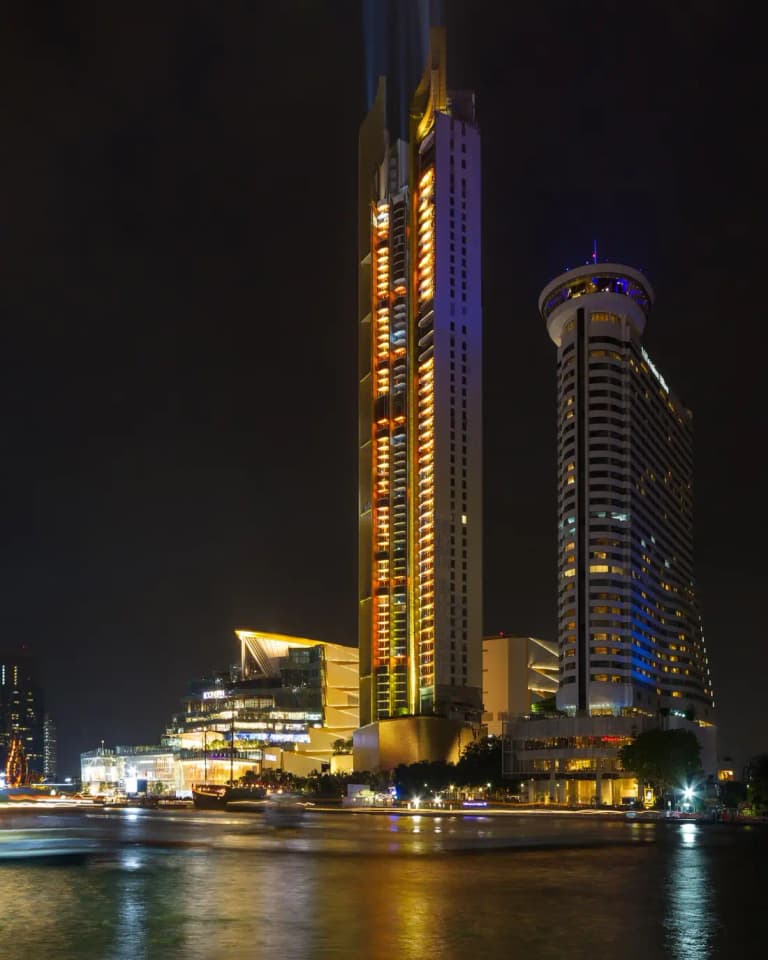 IconSiam shopping complex and its riverside towers lit up at night on the Chao Phraya River