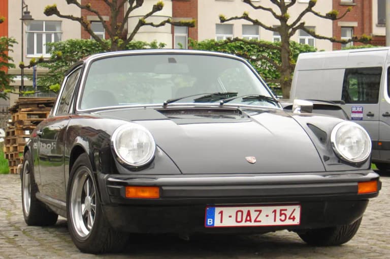 Black 1976 Porsche 912E front three-quarter with impact bumpers