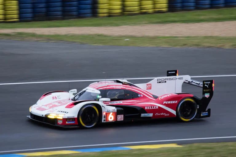 Number 6 Porsche 963 in Penske livery at speed on track at the 24 Hours of Le Mans