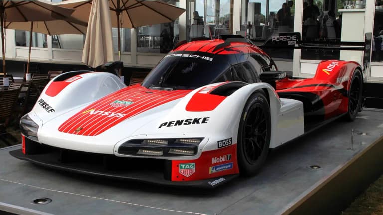 Porsche 963 LMDh prototype in Porsche Penske Motorsport red, white and black livery on display