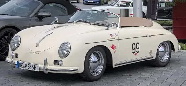 Cream Porsche 356 Speedster with its low windshield and top folded down
