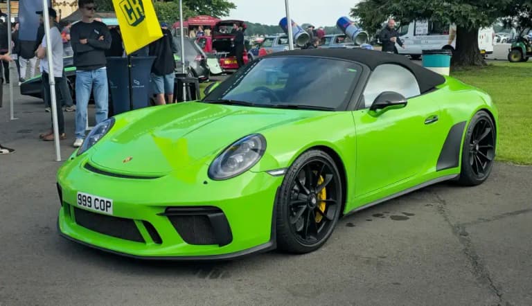 Bright green Porsche 991 911 Speedster with its low windshield, front three-quarter view