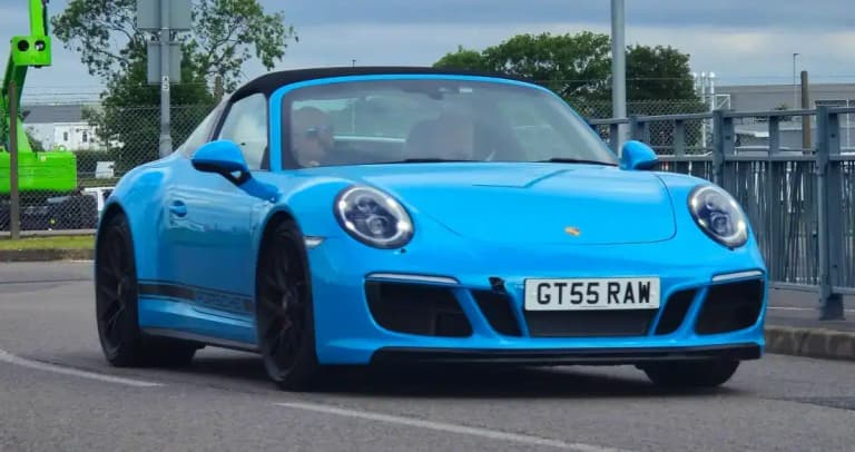 Blue Porsche 911 Targa 4 GTS with its fixed roll hoop and wraparound rear glass