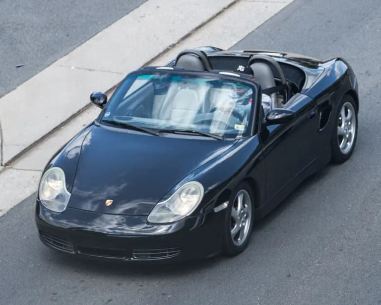 Black first-generation Porsche 986 Boxster with the roof down, seen from above