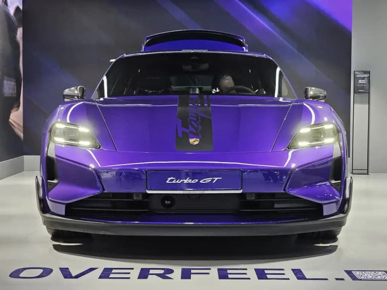 Purple Porsche Taycan Turbo GT front view on a motor show stand