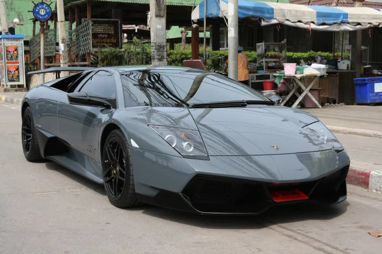 Grey Lamborghini Murcielago LP670-4 SV parked on a roadside in Thailand