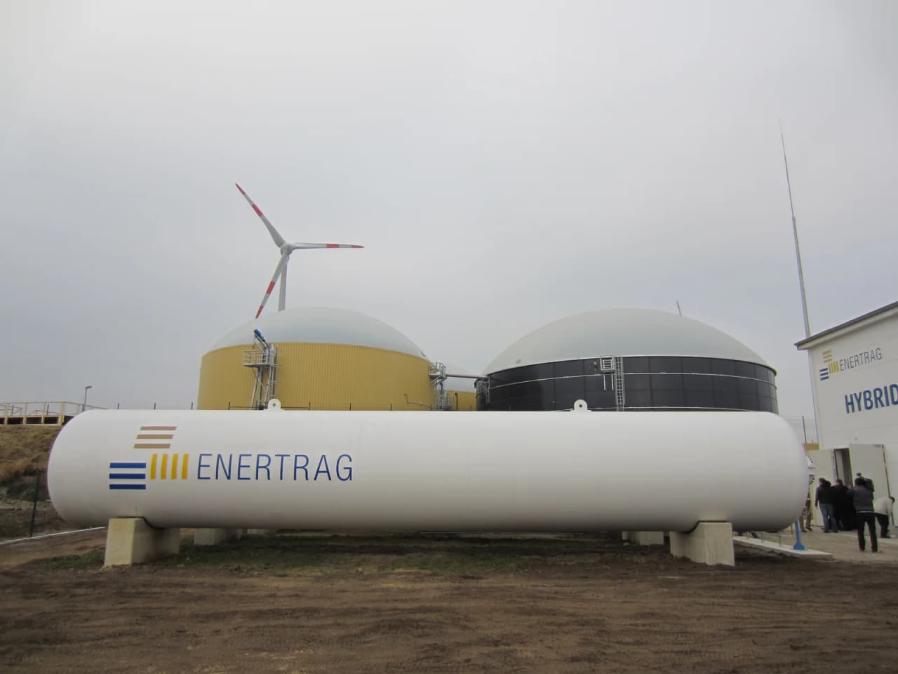 Gas storage tanks, a biogas plant and a wind turbine at a hybrid power plant in Prenzlau, Germany
