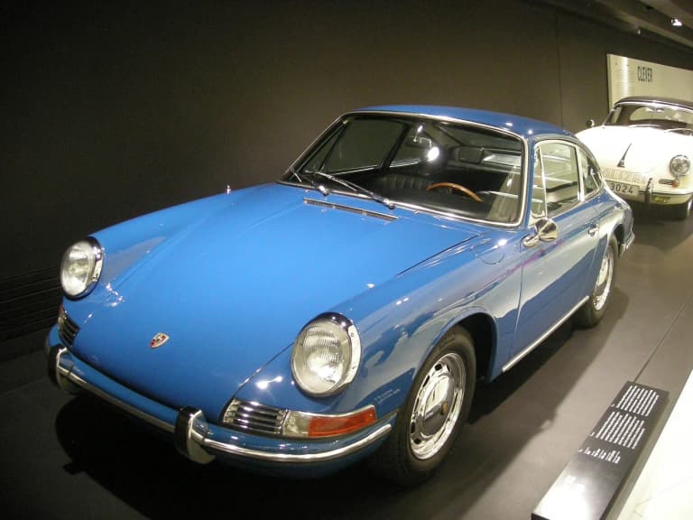 Blue 1965 Porsche 911 on display at the Porsche Museum.