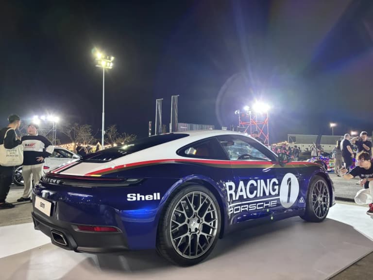 Porsche racing livery car displayed at a Bangkok car event