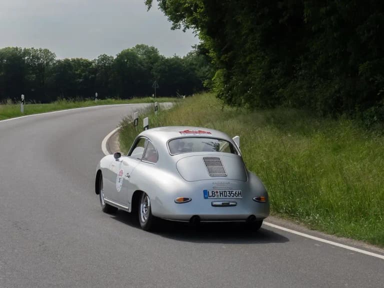 Silver Porsche 356, one of the classic cars Thailand collectors prize, on a country road