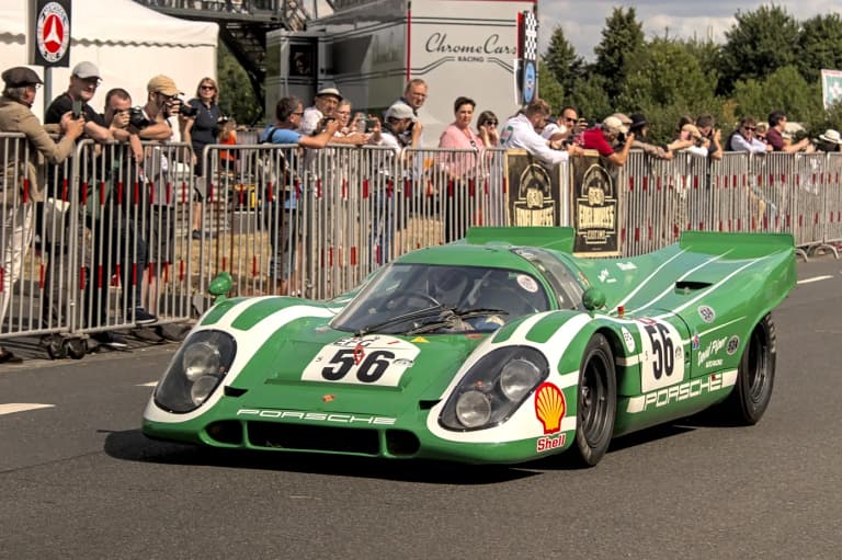 Green and white Porsche 917K race car at a historic motorsport event
