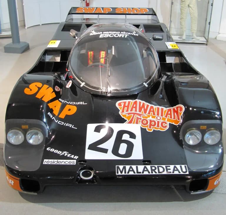 Black Swap Shop Porsche 962 number 26 front view on display