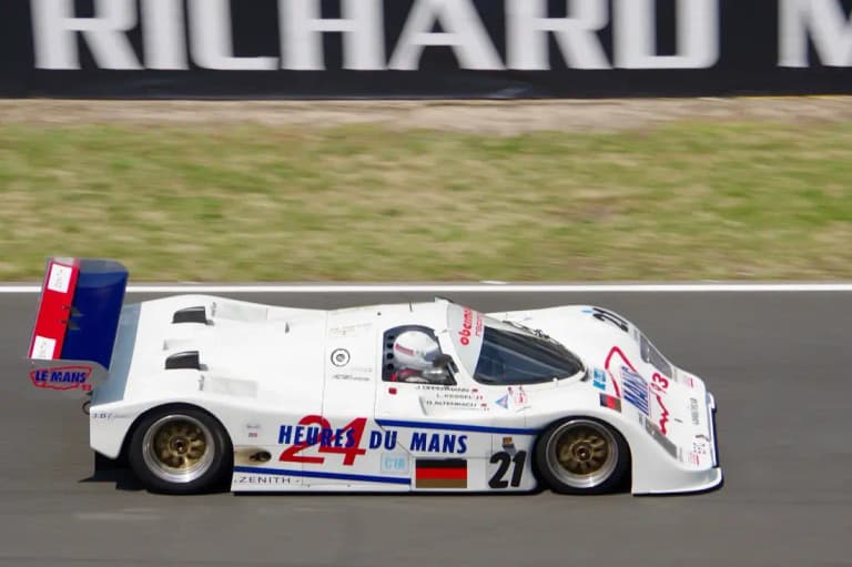 White 24 Heures du Mans Porsche 962C number 21 at speed on track