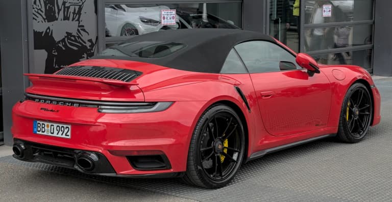 Red Porsche 992 Turbo S Cabriolet with soft top closed