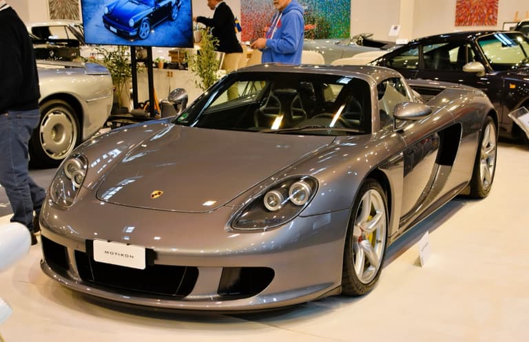 Gray Porsche Carrera GT shown from the front three-quarter with the roof in place