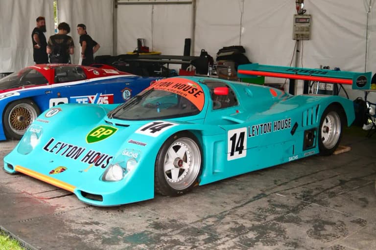 Light blue Leyton House liveried Porsche 962C in a paddock tent