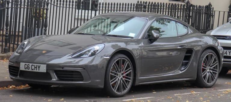 Gray Porsche 718 Cayman S on a city street, a 7-speed PDK model