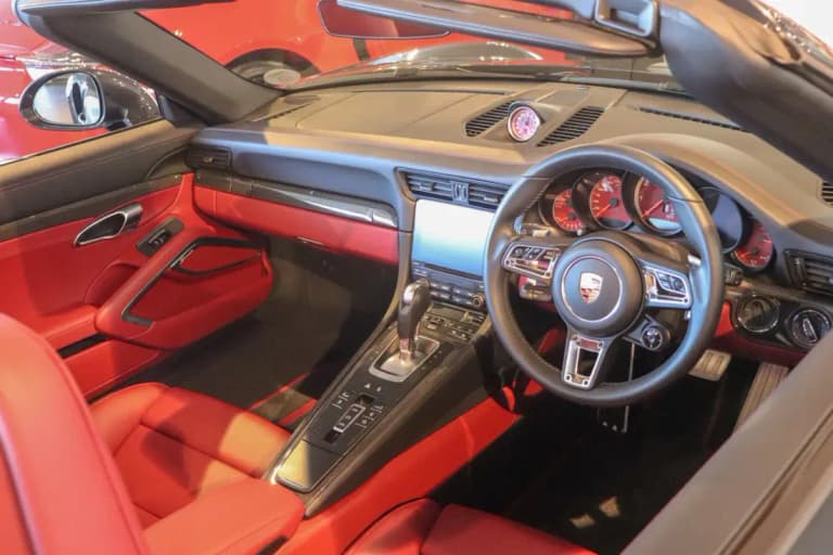 Porsche 911 interior with Porsche PDK gear selector and red sport leather seats