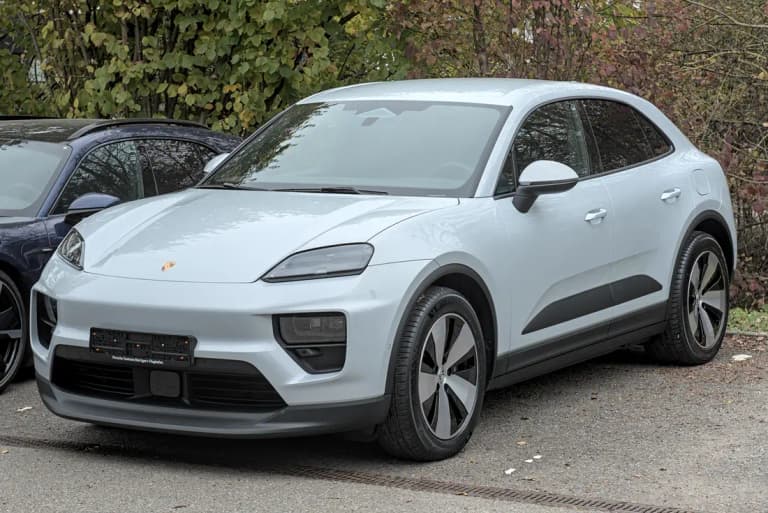 Light gray Porsche Macan 4 EV parked outdoors, the all-electric version which uses a different transmission