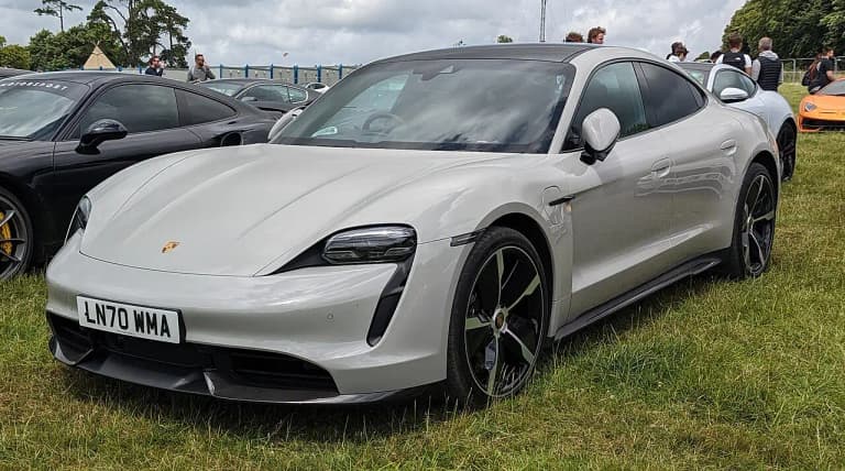Gray Porsche Taycan Turbo S sedan front three-quarter view at a car show