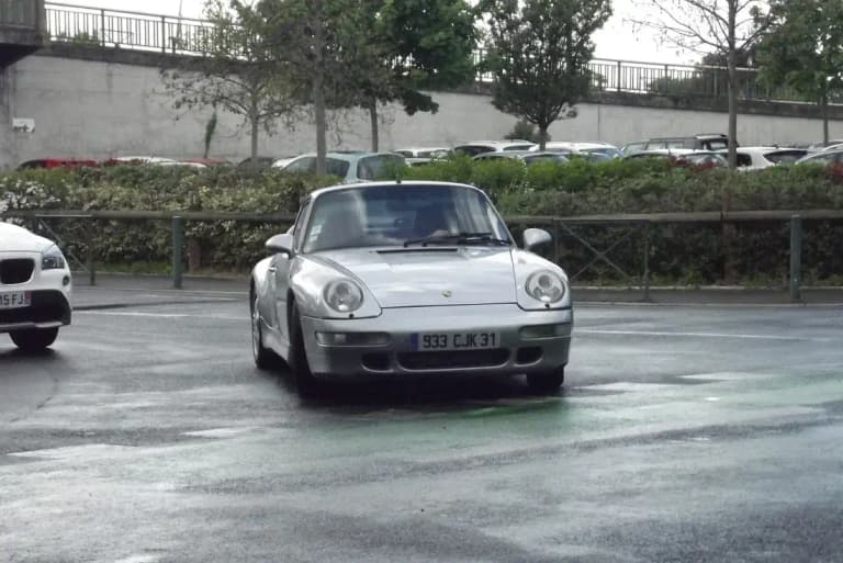 Silver air-cooled Porsche 993 911 Carrera front view