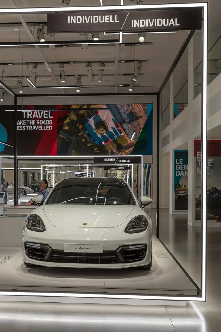 White Porsche Panamera e-hybrid front view on a showroom display
