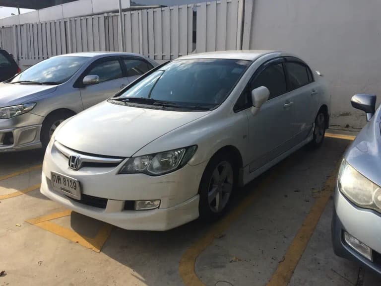 White Honda Civic FD sedan with an aftermarket body kit in a Thai car park
