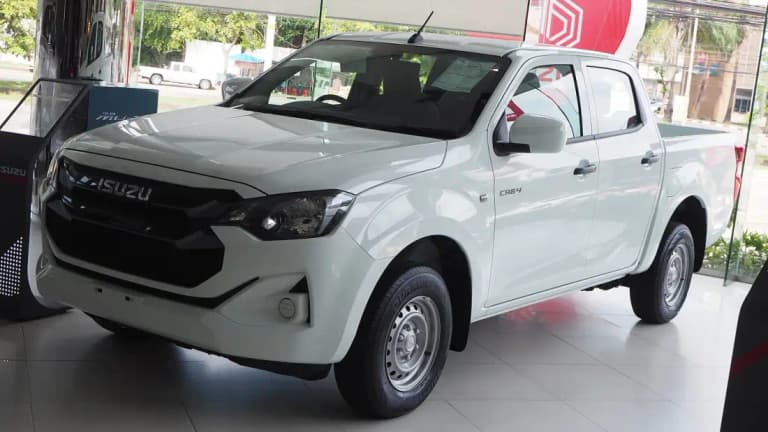 White Isuzu D-Max double cab pickup in a dealership showroom in Thailand