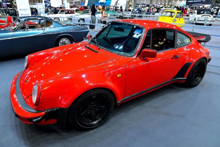 Red Porsche 930 Turbo in the classic car hall at the Thailand International Motor Expo