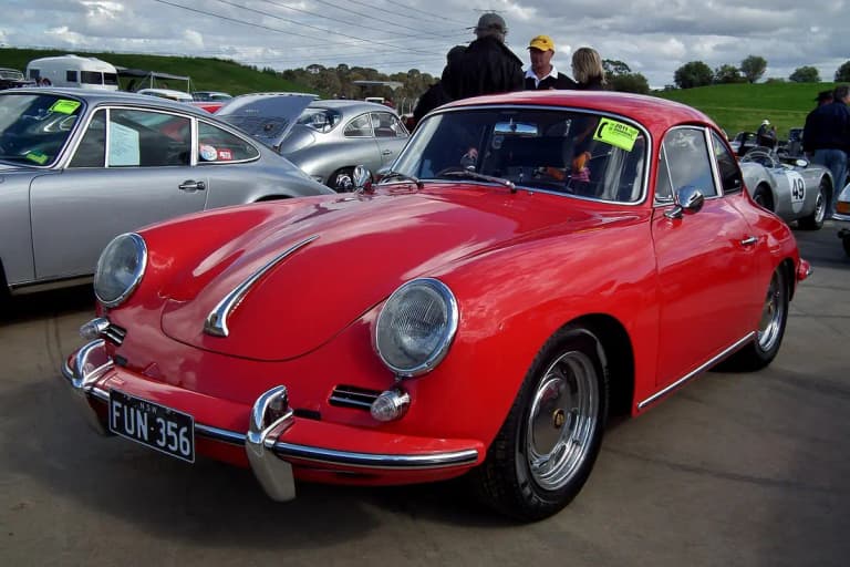 Red Porsche 356 C coupe parked front three-quarter view