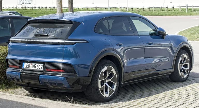 Blue Porsche Cayenne Electric rear three-quarter view with full-width Porsche light bar