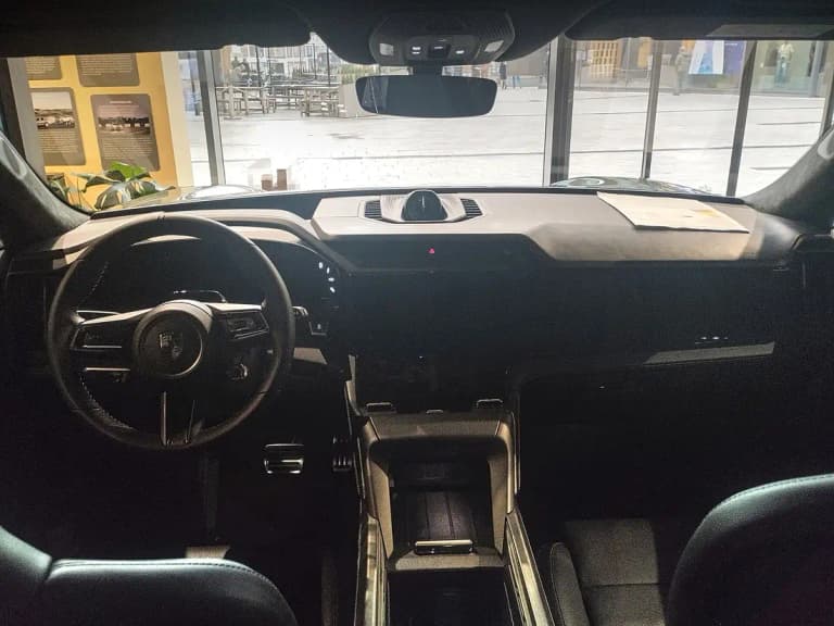 Porsche Cayenne Electric dashboard and curved driver display seen from the rear seats