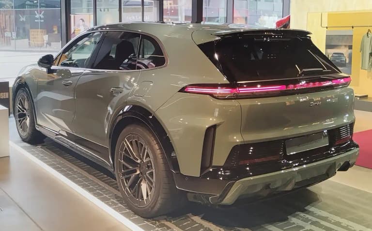 Green Porsche Cayenne Turbo Electric rear three-quarter view with illuminated light bar