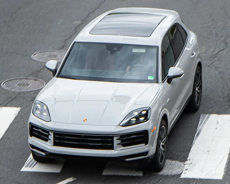 White Porsche Cayenne E-Hybrid, front three-quarter view from an elevated angle