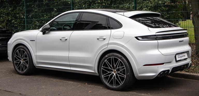 Facelift Porsche Cayenne E-Hybrid Coupe, rear three-quarter view showing the full-width light bar