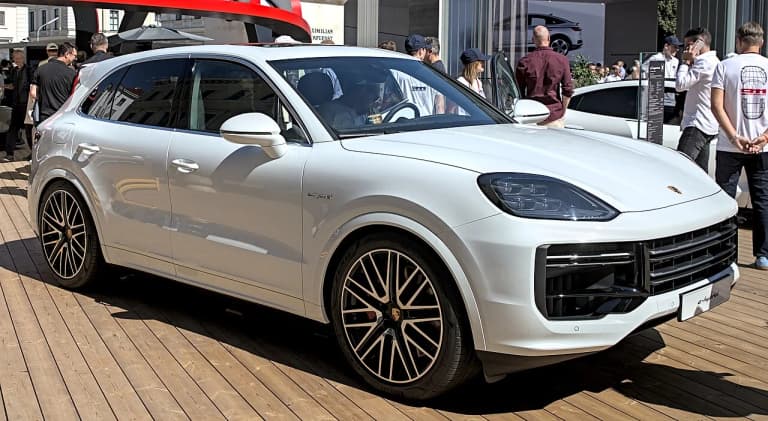 White Porsche Cayenne Turbo E-Hybrid, front three-quarter view at a motor show