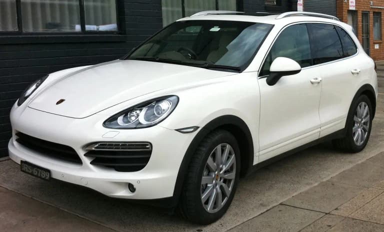 White second-generation Porsche Cayenne S (958), front three-quarter view