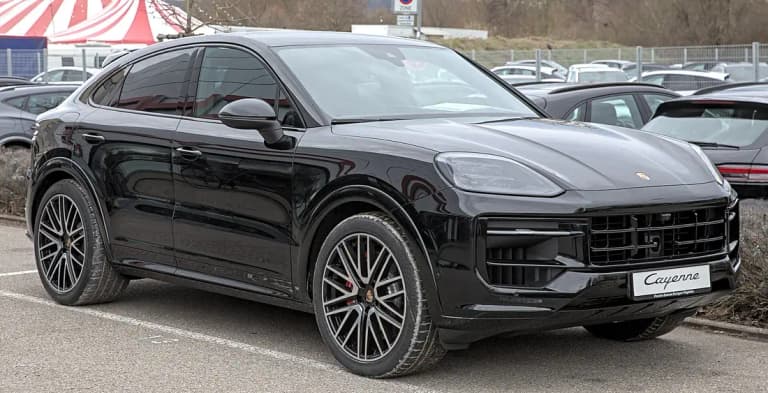 Black Porsche Cayenne S Coupe, front three-quarter view parked at a dealership