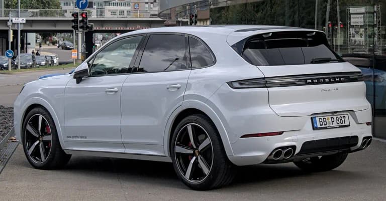 White Porsche Cayenne S, rear three-quarter view showing the Cayenne S badge and light bar