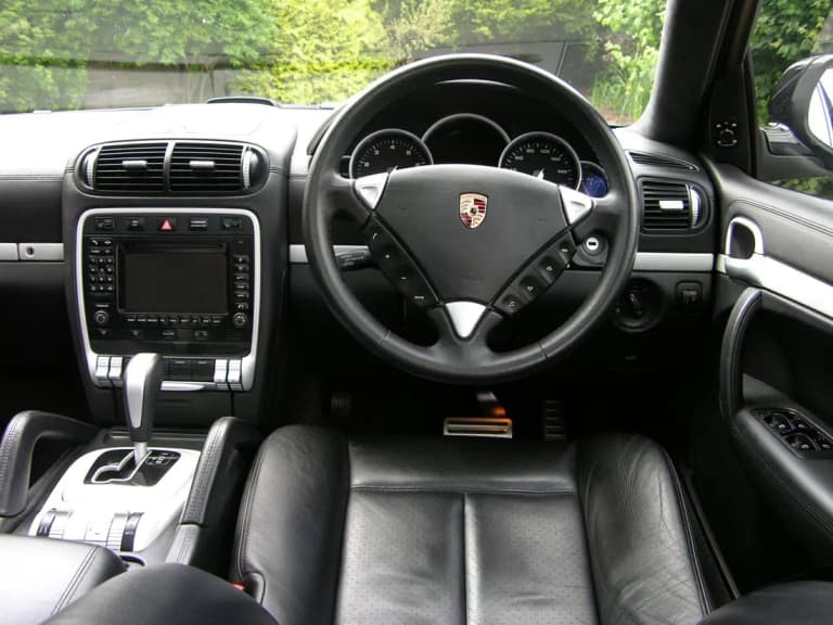 First-generation Porsche Cayenne Turbo dashboard and steering wheel in black leather