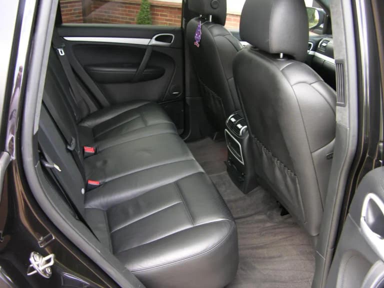Rear seats of a first-generation Porsche Cayenne Turbo in black leather