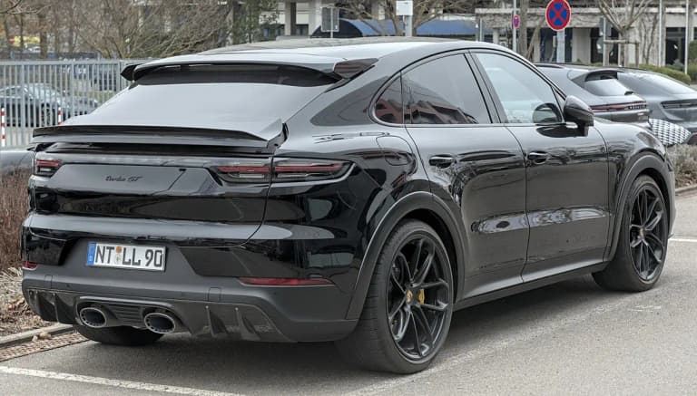 Black Porsche Cayenne Turbo GT rear three-quarter view with fixed roof spoiler