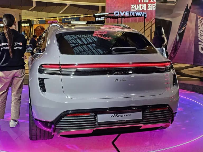 Gray Porsche Macan EV rear view with full-width light bar