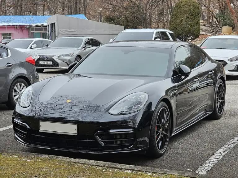 Black second-generation Porsche Panamera GTS, front three-quarter view with black 20-inch wheels